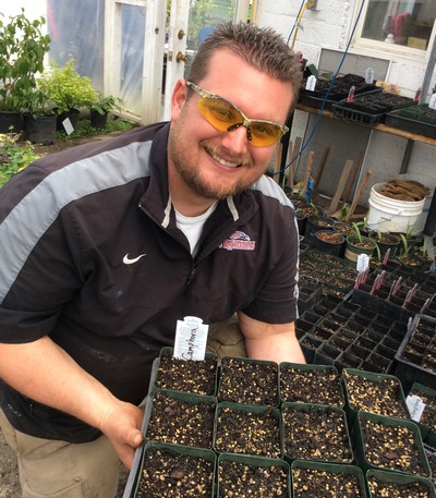 SOU Greenhouse Manager Michael Oxendine, Ph.D, with newly planted seeds
